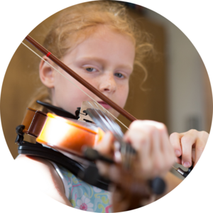 A young girl learning how to play the violin.